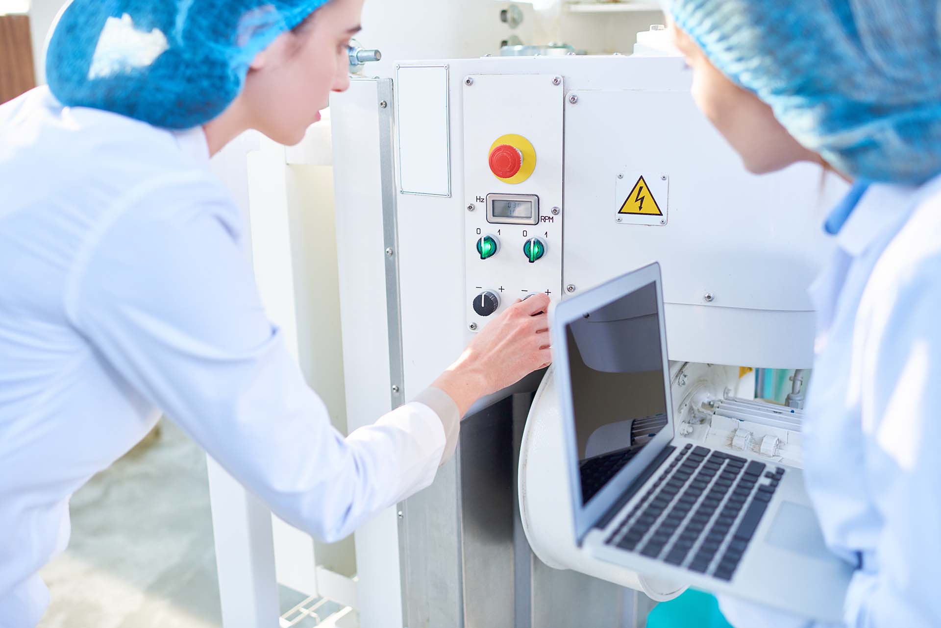 Technician operating machine in KeyMedical cleanroom