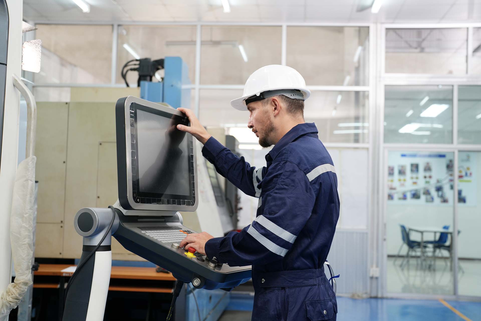 KeyPrecision technician operating an injection moulding machine
