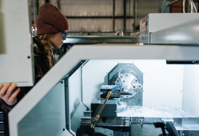 Technician operating a CNC milling machine in KeyPrecision