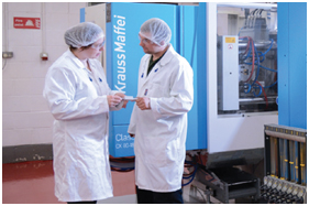 KeyMedical engineers with Krauss Maffei injection moulding machine in background