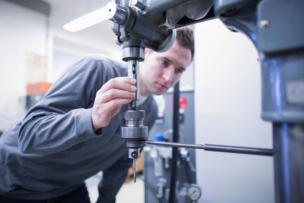 Young trainee examining equipment