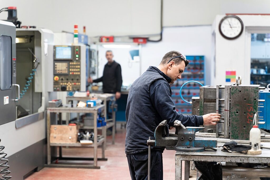 Key Precision lathe worker repairing metal mould